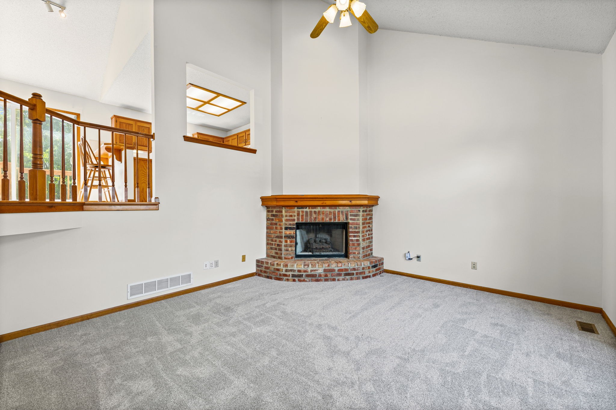 Vaulted living room with gas fireplace and new carpet at 6409 Chouteau Street, Shawnee KS