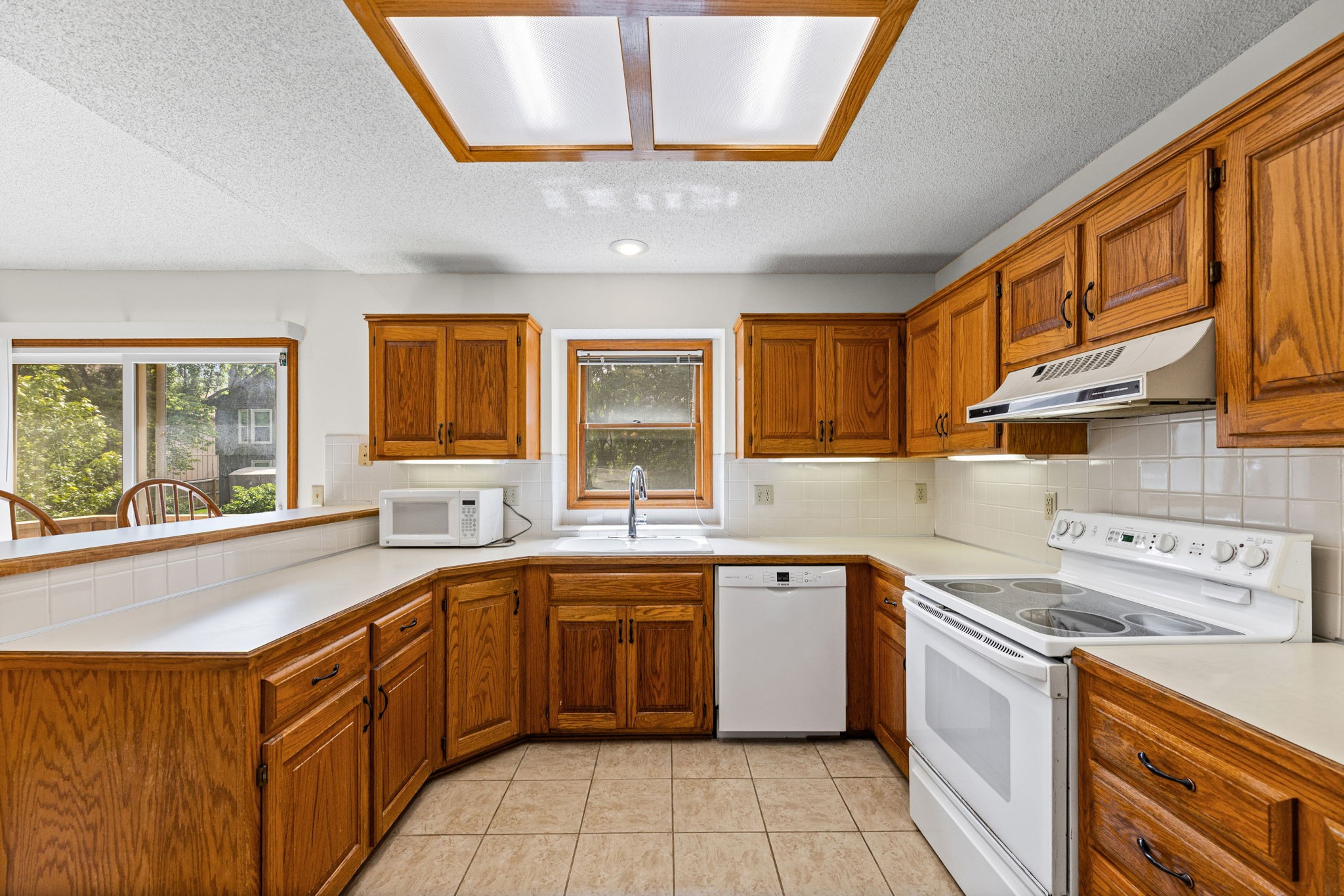 Kitchen with oak cabinets and window over the sink at 6409 Chouteau Street, Shawnee KS