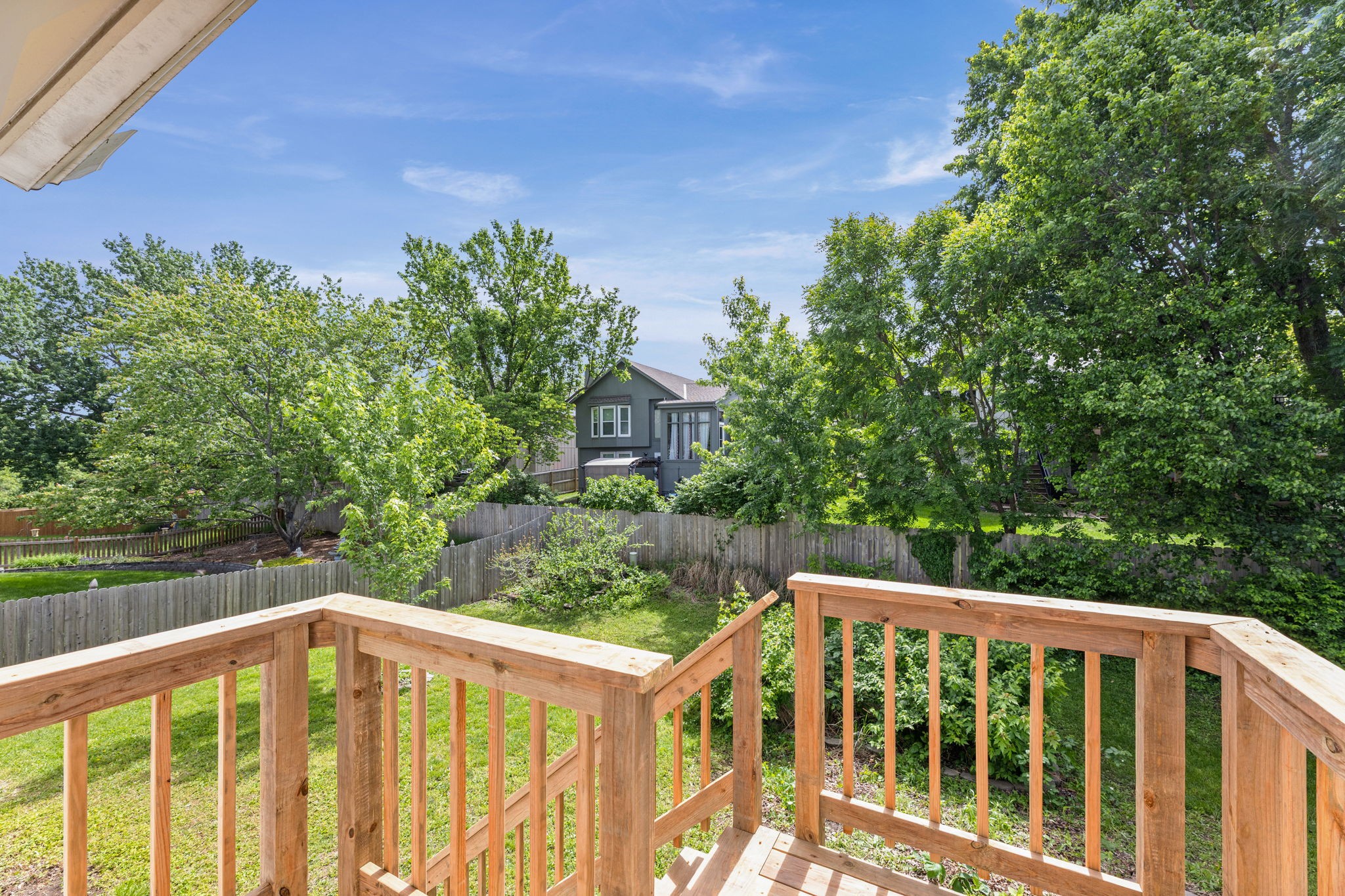 View from the new deck over the privacy-fenced backyard at 6409 Chouteau Street, Shawnee KS