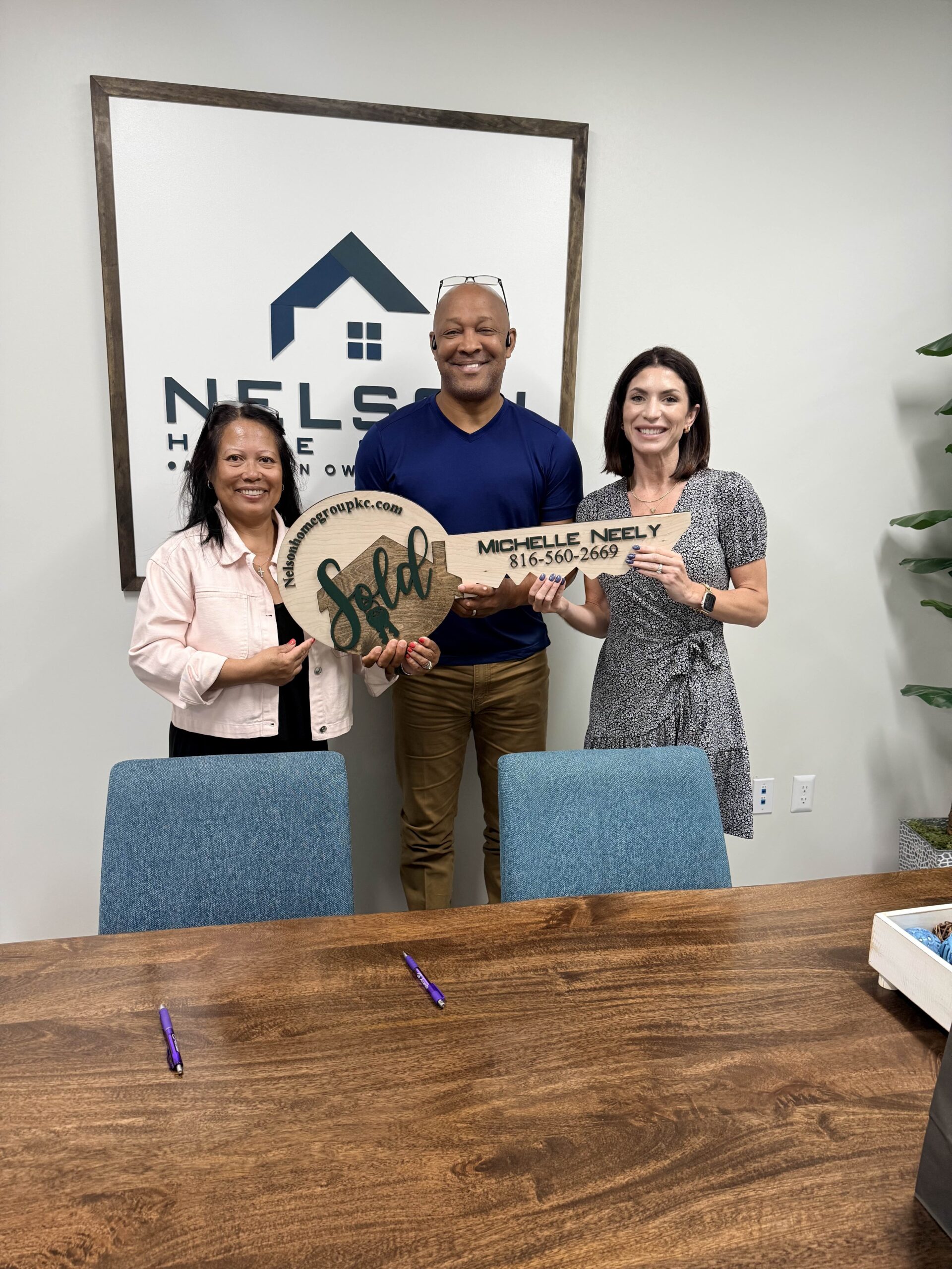 Investor Anthony and his family with Nelson Home Group agent Michelle Neely after selling the renovated 119 Sherri Lane flip in Excelsior Springs, MO