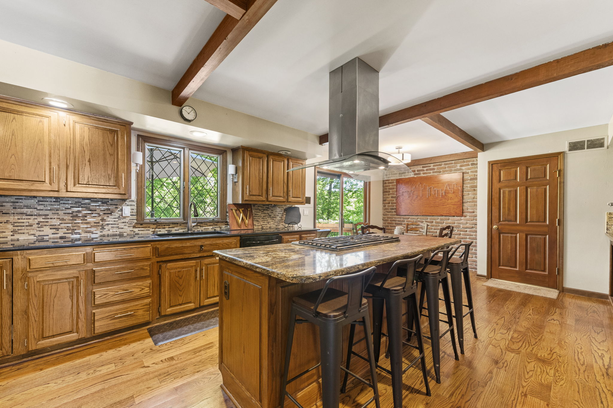 Chef's kitchen with a granite island, gas cooktop and double ovens