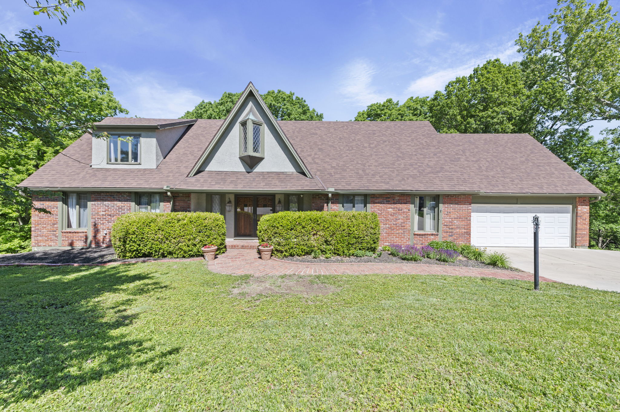 616 NW 42nd Terrace, a 1.5-story home on a wooded cul-de-sac in the Claymont neighborhood of Kansas City's Northland