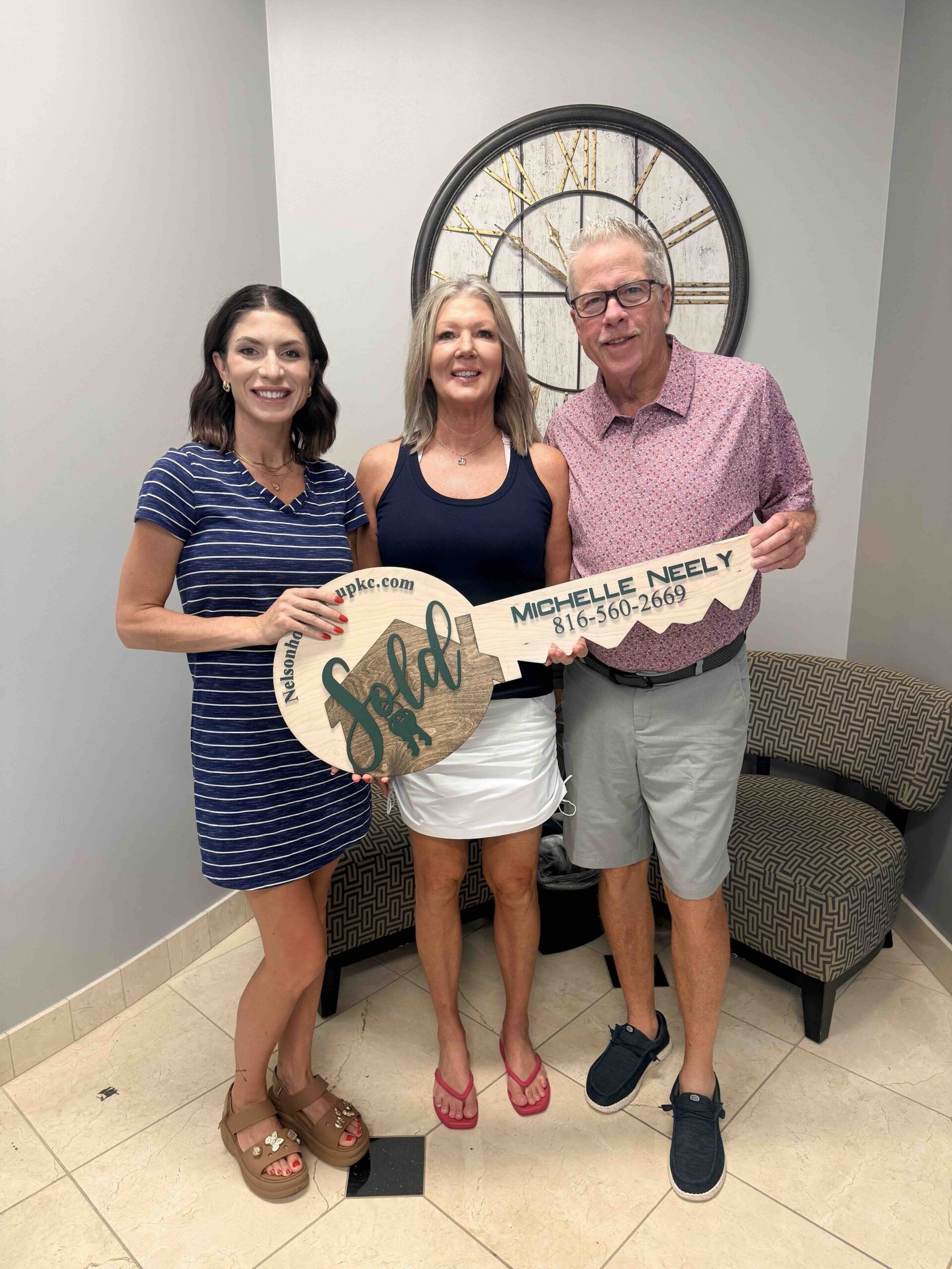 Randy and Ranay at closing on their Weatherby Lake pool home with Nelson Home Group agent Michelle Neely