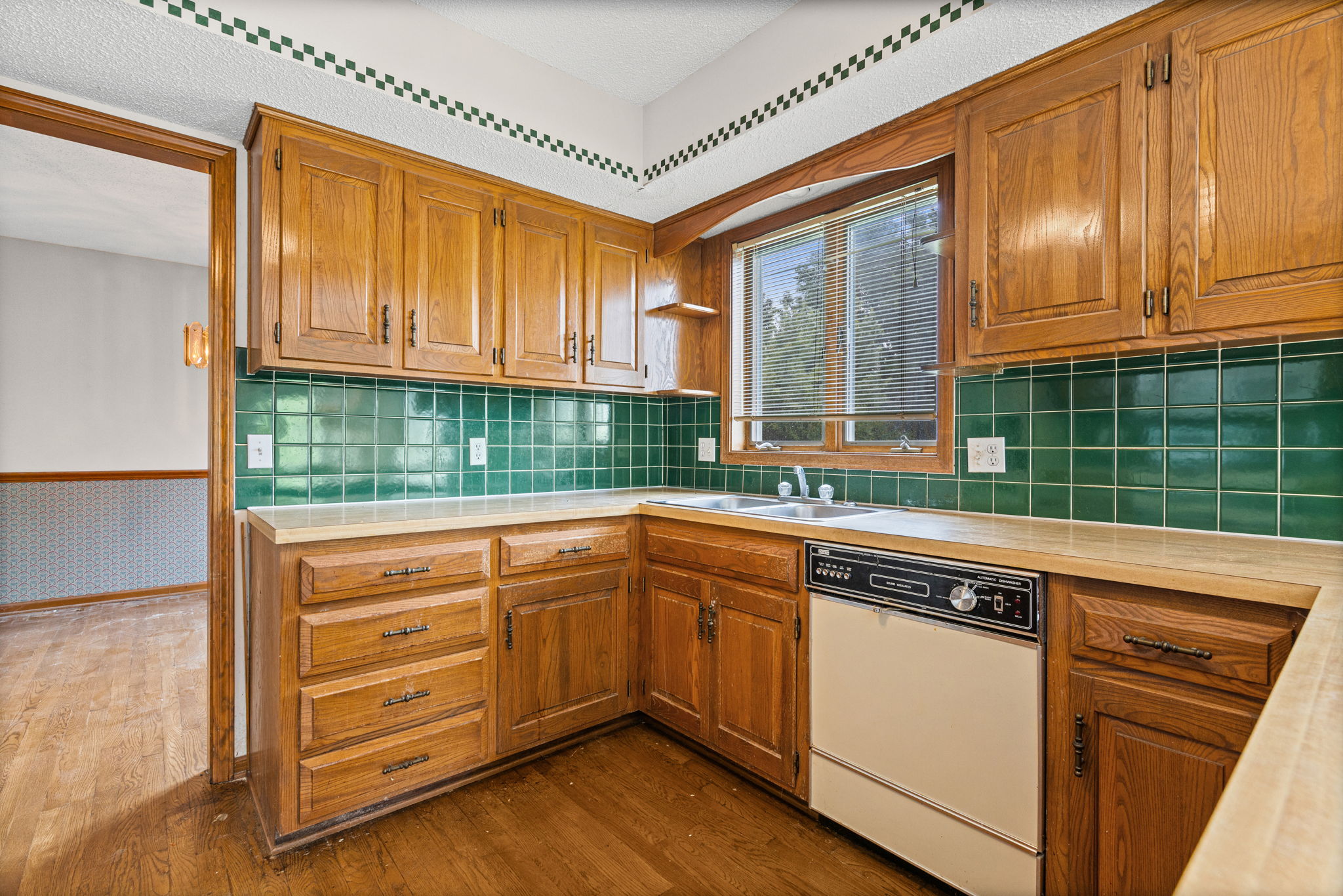 The kitchen, with its original stained oak cabinetry