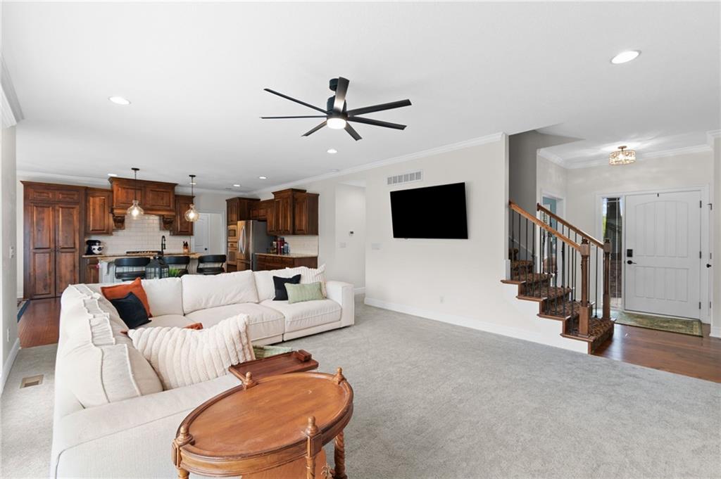 Open-concept living room with hardwood floors and staircase