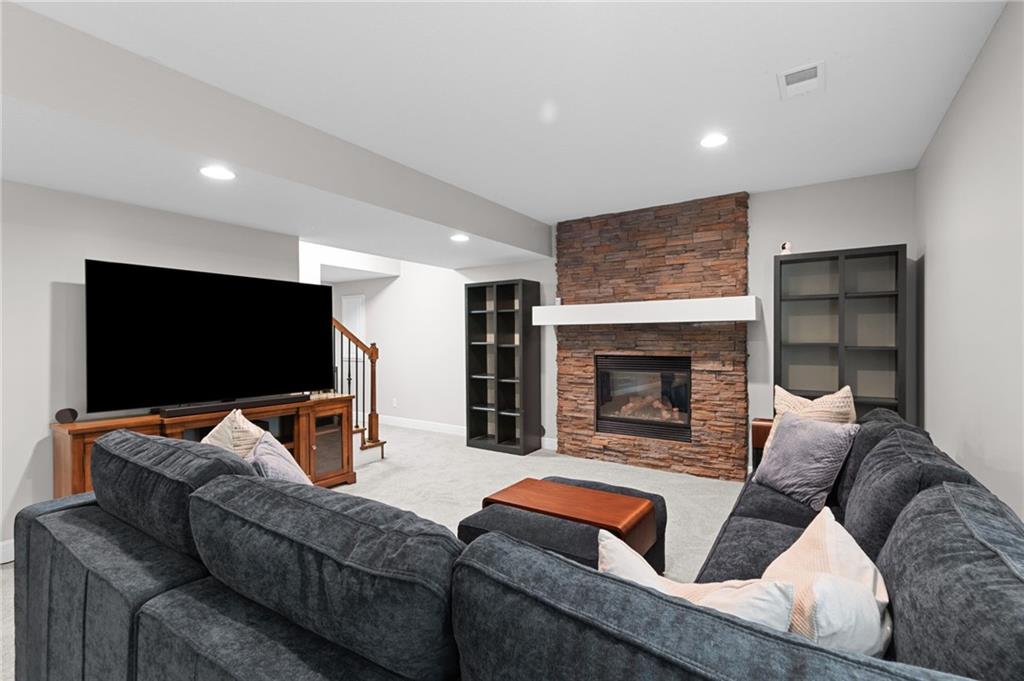 Recreation room with floor-to-ceiling stone gas fireplace