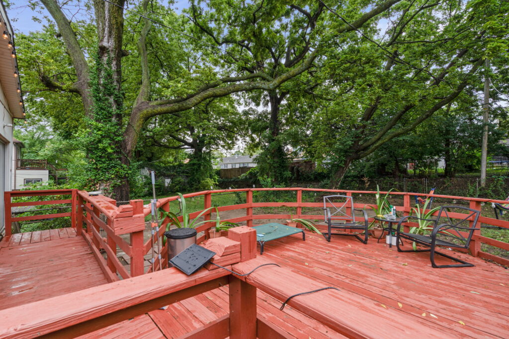 Wood rear deck under mature trees behind a Kansas City, Missouri home