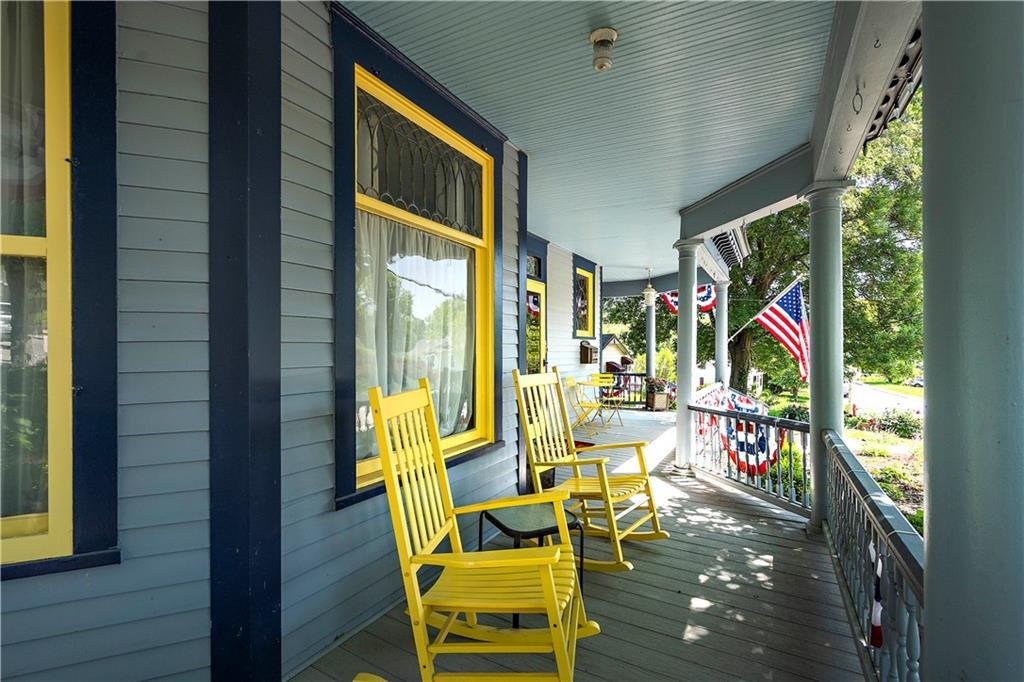 Covered front porch with yellow rockers at 908 Washington Street, Weston, MO