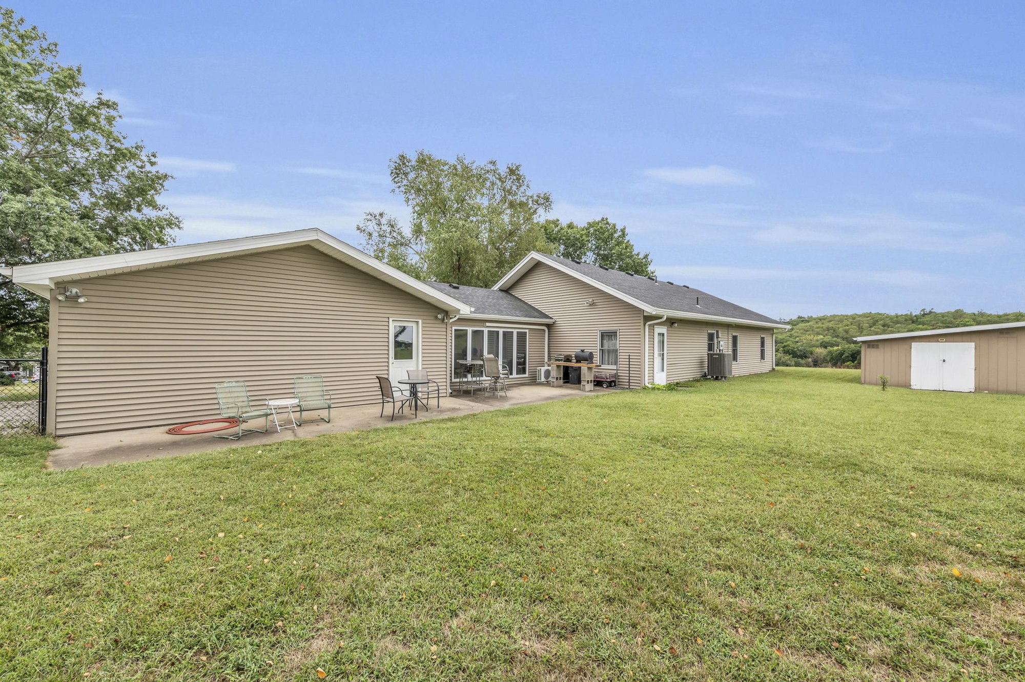 Rear exterior and half-acre yard at 111 Cora Drive, Weston, MO