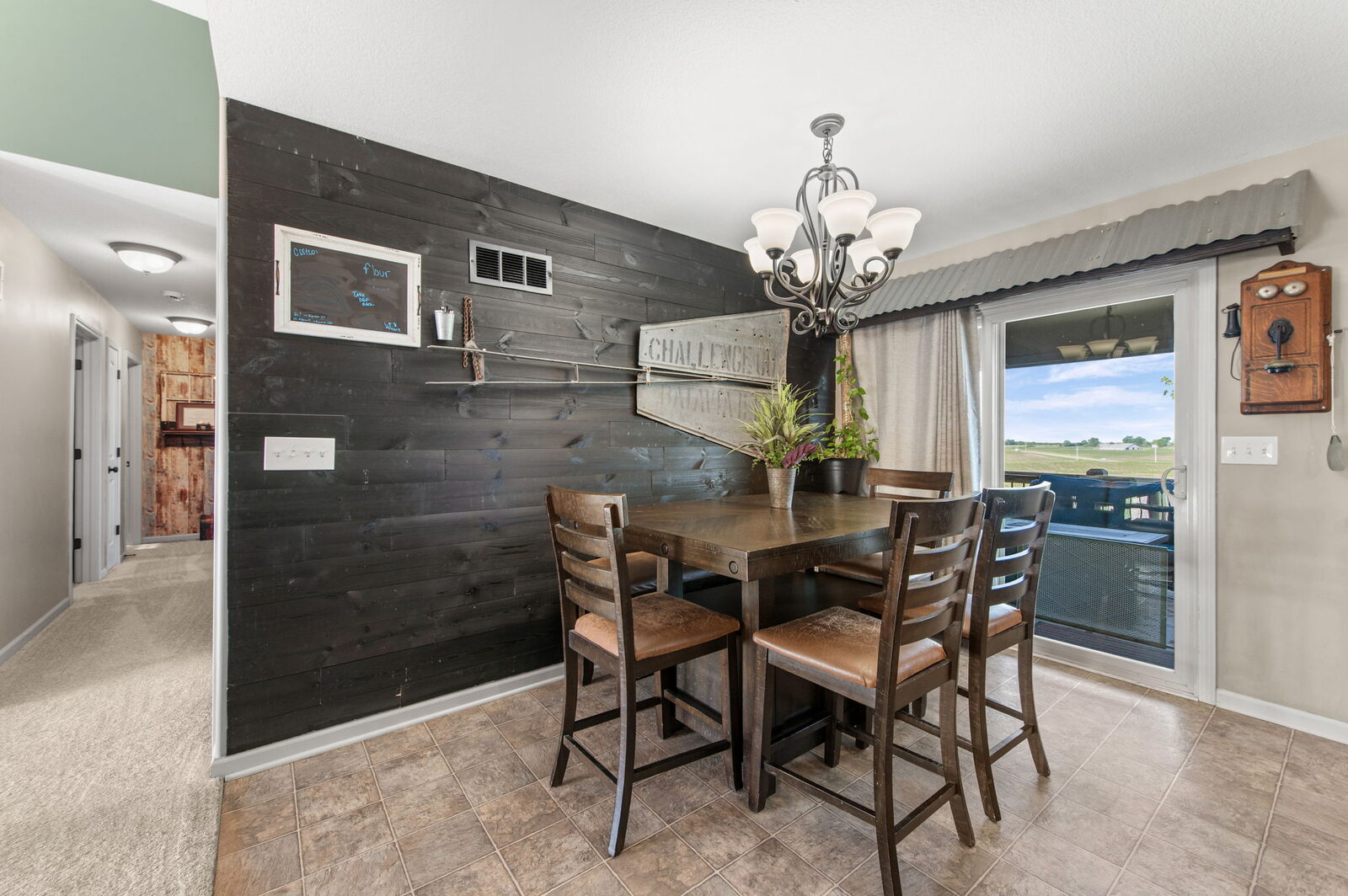 Dining area with shiplap accent wall and deck access at 19204 Corbyn Lane, Smithville, MO