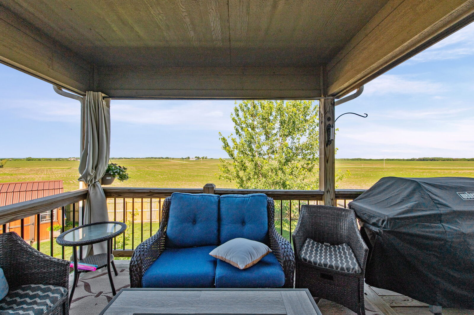 Covered deck overlooking open field at 19204 Corbyn Lane, Smithville, MO