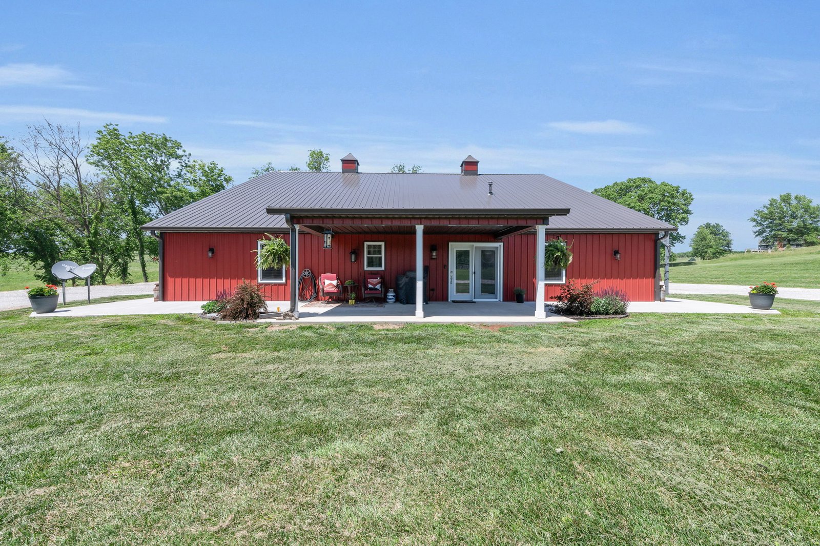 Front elevation of the Weston barndominium showing the covered front patio and metal roof