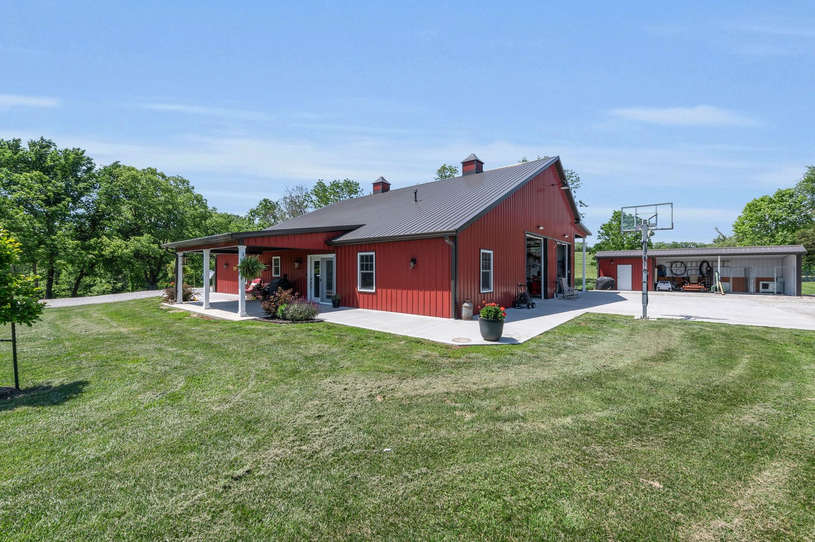 Open backyard and lawn behind the Weston barndominium on 7.69 acres