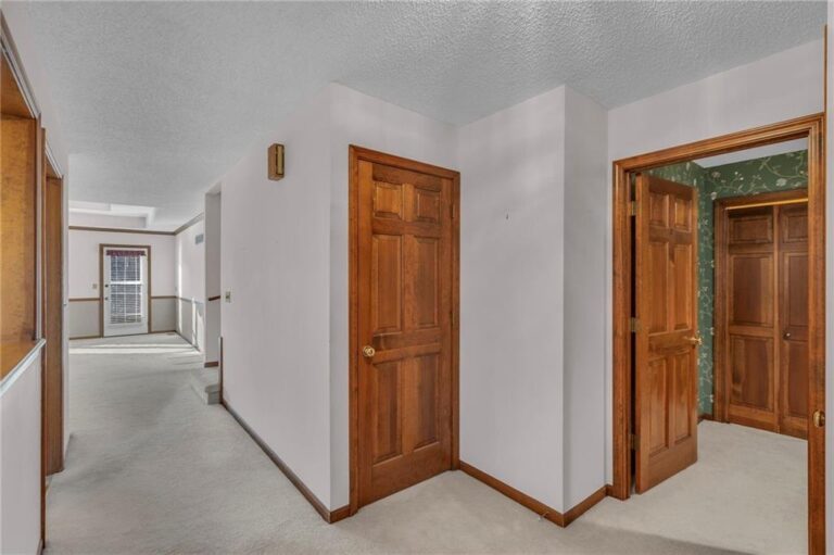 Upper landing and hallway looking toward the living room at 7020 N Garfield Avenue in Gladstone, Missouri