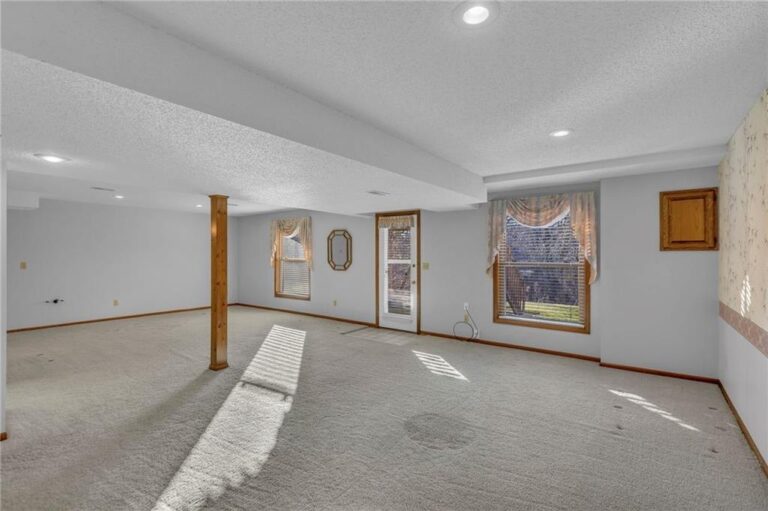 Finished walkout lower level with daylight windows and a door to the backyard at 7020 N Garfield Avenue, Gladstone, Missouri