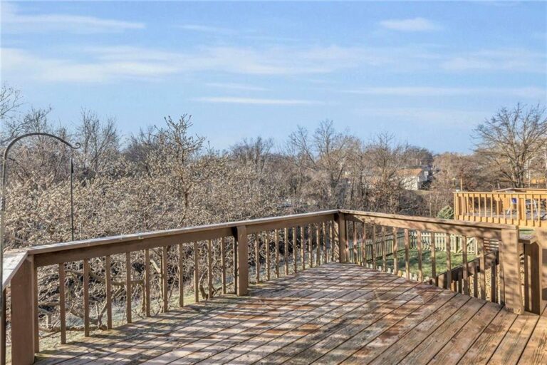 Elevated deck overlooking mature trees behind 7020 N Garfield Avenue in Gladstone, Missouri