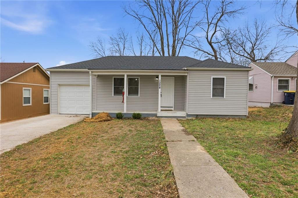 Front exterior of a 1953 ranch with an attached garage and covered porch in the Crestview subdivision of Kansas City, Missouri