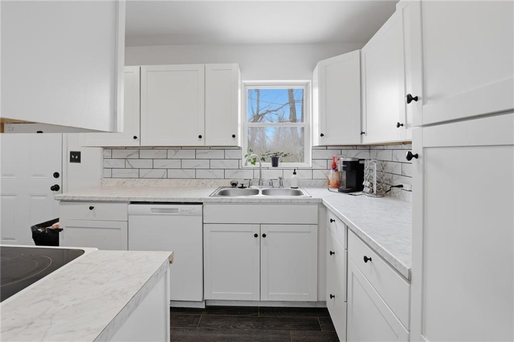 Updated white kitchen with subway tile backsplash and marble-look counters in Crestview, Kansas City, Missouri
