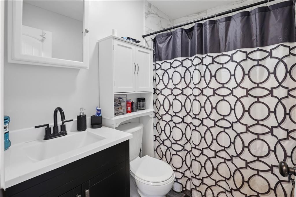 Updated bathroom with black vanity in Crestview, Kansas City, Missouri