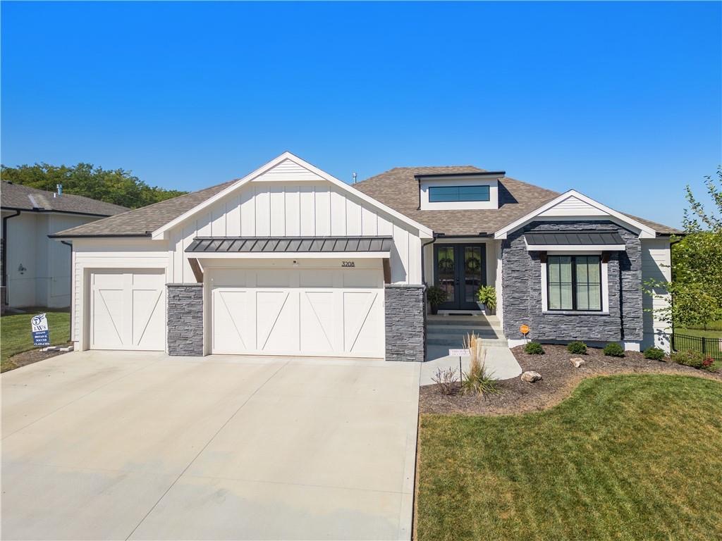 Front exterior of a 2023-built reverse 1.5 story ranch with a 3-car garage in Summit View Farms, Lee's Summit, Missouri