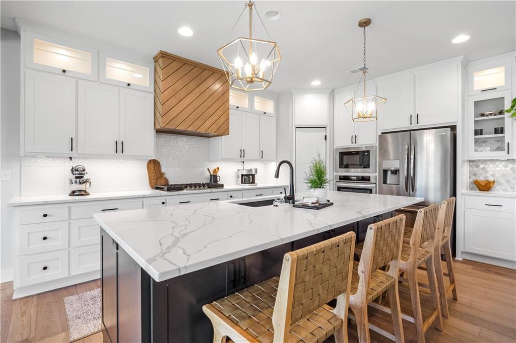Kitchen with quartz island and white cabinetry in Summit View Farms, Lee's Summit, Missouri