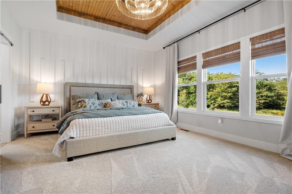 Main-floor primary bedroom with vaulted ceiling in Summit View Farms, Lee's Summit, Missouri