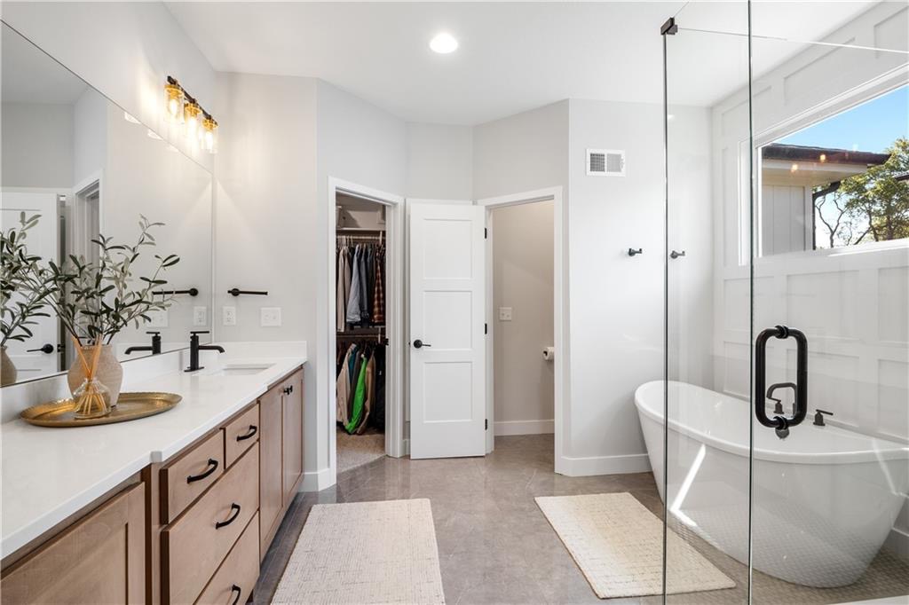 Primary bathroom with soaking tub and walk-in shower in Summit View Farms, Lee's Summit, Missouri