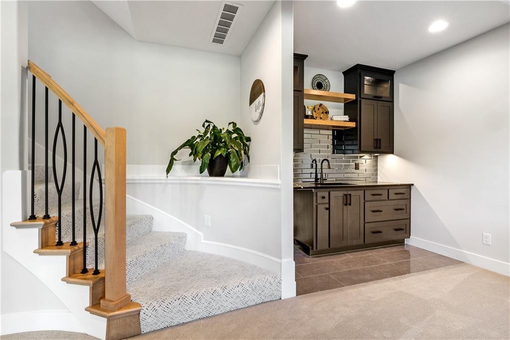Lower level wet bar and staircase in Summit View Farms, Lee's Summit, Missouri