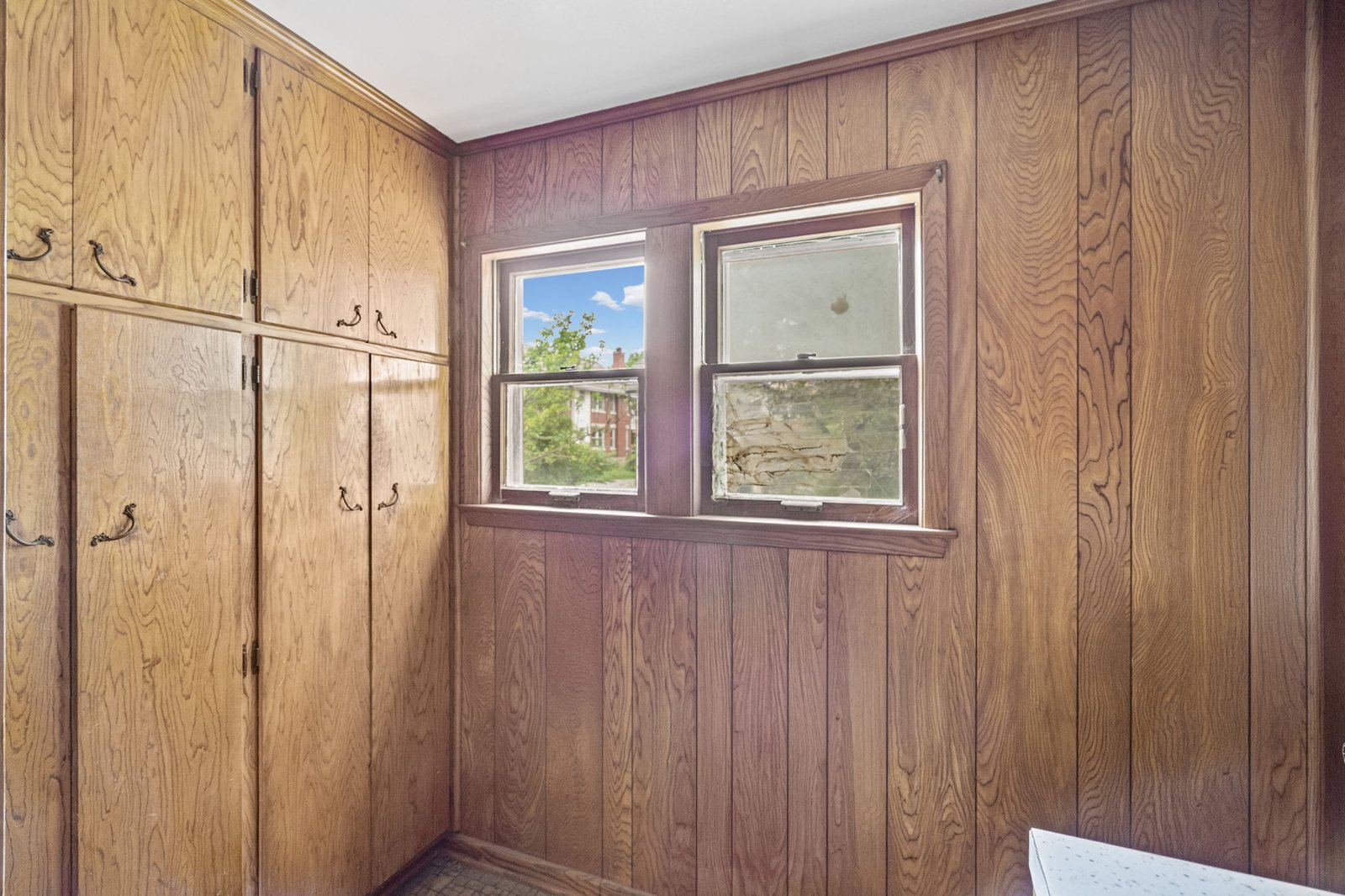 Mudroom and drop zone with floor-to-ceiling built-in storage in this Epperson Place bungalow