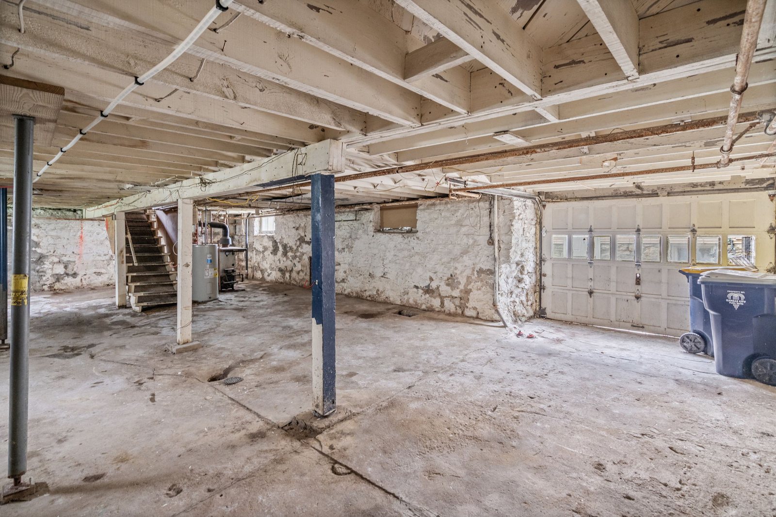 Unfinished stone-walled basement in this Epperson Place bungalow