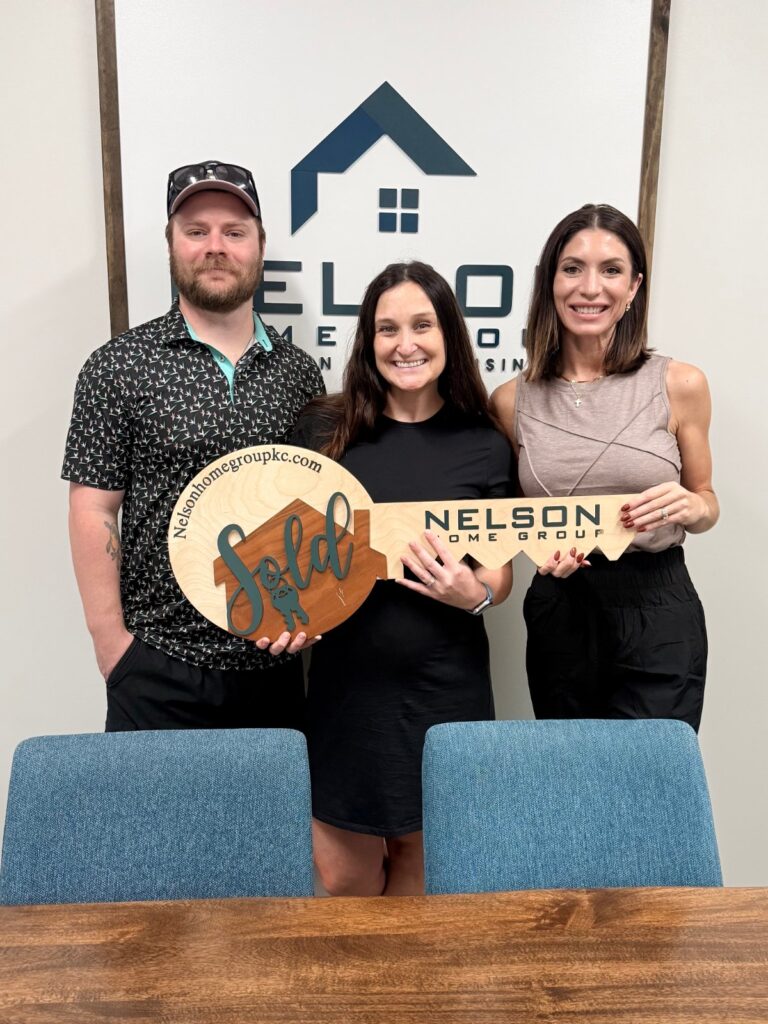 Sellers Hunter and Becky with Nelson Home Group agent Michelle Neely at closing on 1126 E Charlotte Town Road, Olathe, KS