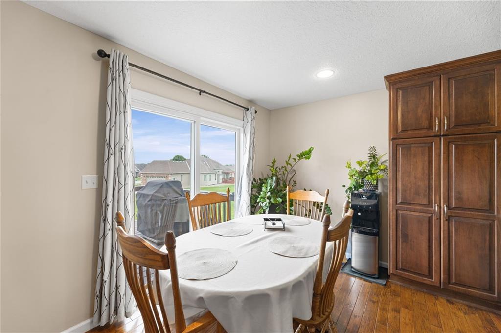 Dining area with a sliding door to the back deck and a tall pantry cabinet in a ranch home in Cameron, Missouri