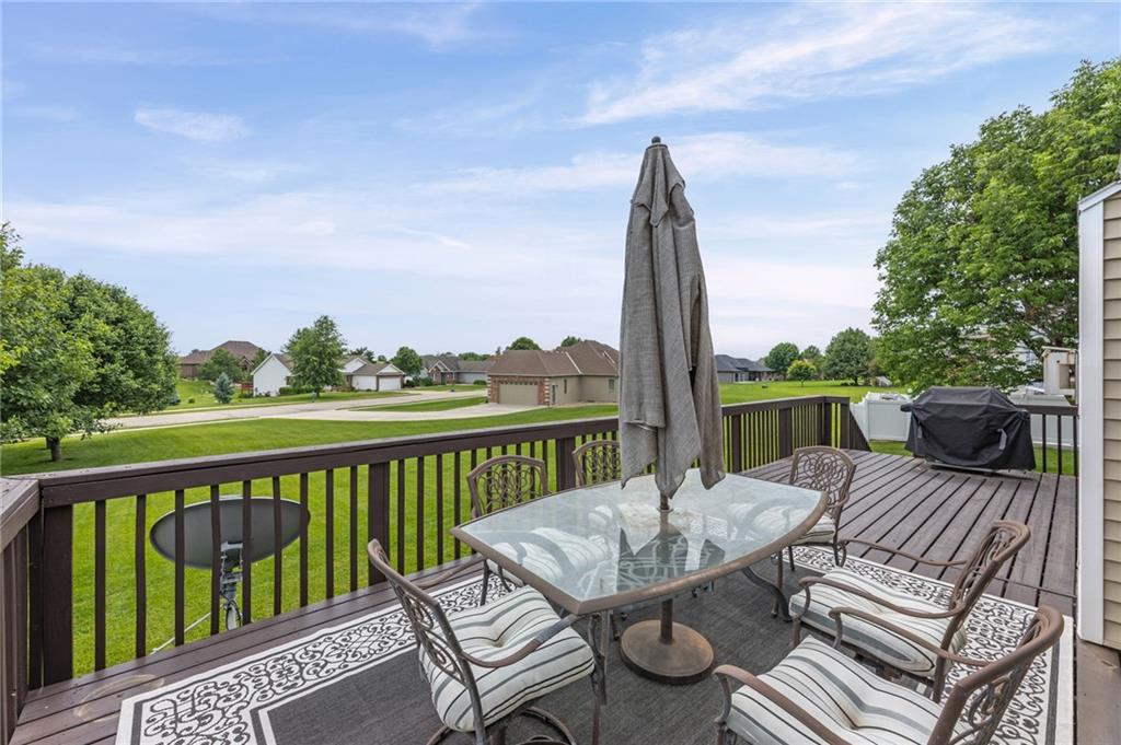 Back deck with a patio table overlooking open lawns in the Eagle's Landing neighborhood of Cameron, Missouri