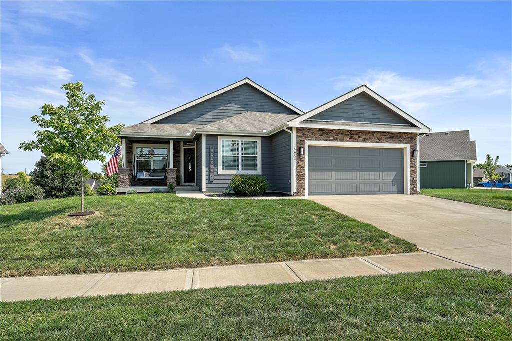 Front exterior of a ranch home with a two-car garage in Fiddler's Ridge, Weston, MO