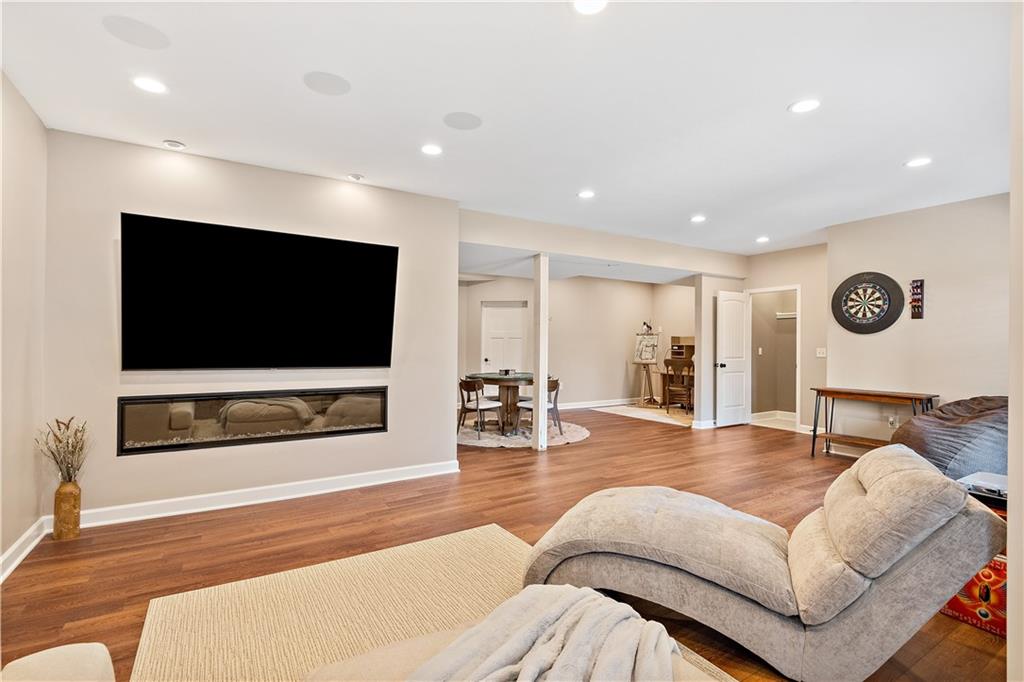 Finished lower-level family room with a second fireplace in a Weston, MO ranch home