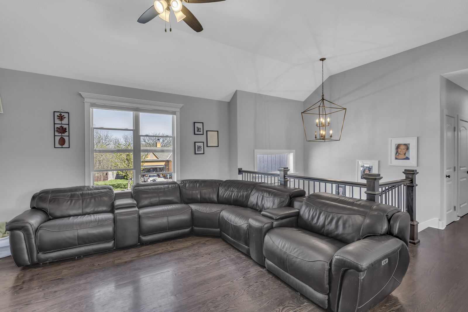Living room with fireplace, built-in shelving and wood floors in a Weston, Missouri home