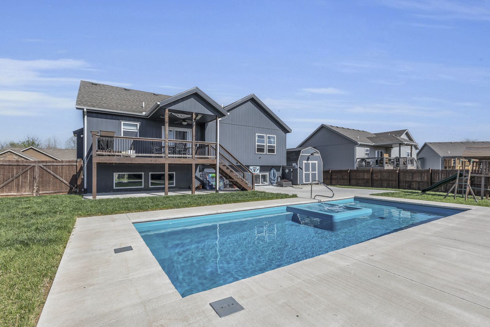 Heated and chilled saltwater pool and spa in a privacy-fenced backyard in Weston, Missouri