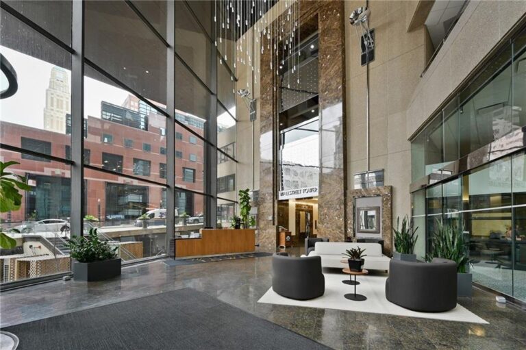 Two-story building lobby with lounge seating and floor-to-ceiling glass, Wallstreet Towers, downtown Kansas City, MO