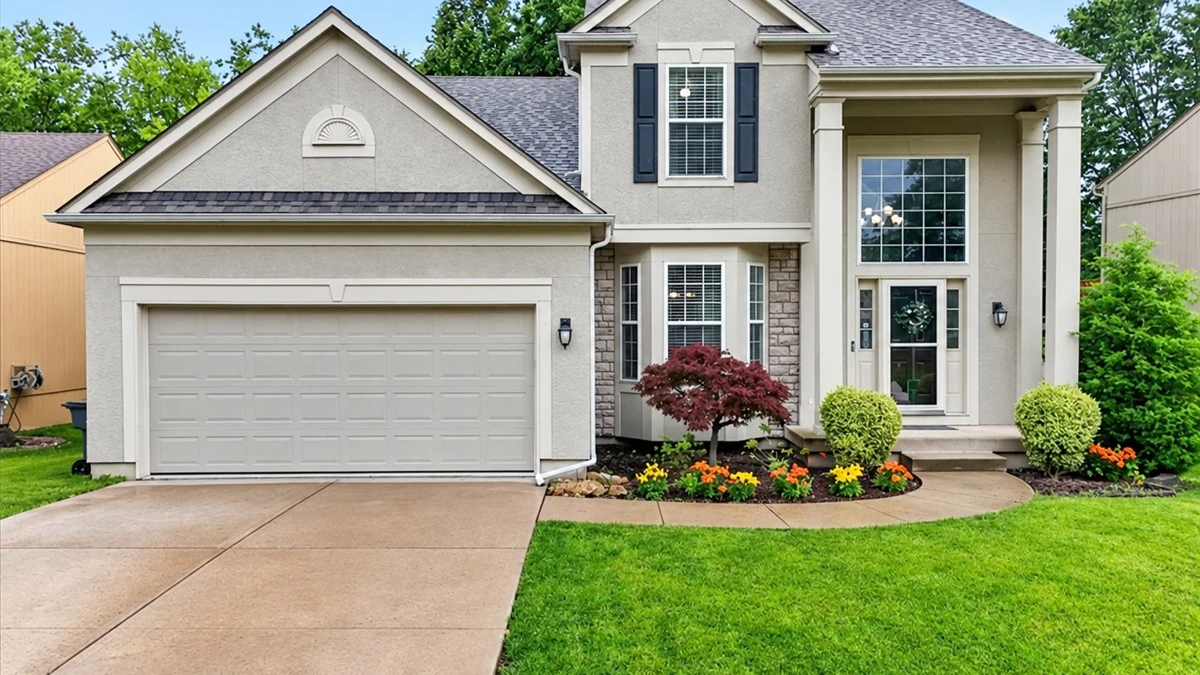 Two-story stucco home with a two-car garage in Woodland Creek, Olathe, Kansas