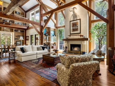 Secluded 70-acre estate featuring a hand-hewn timber-frame home, guest cottage, rolling pasture, mature woods, and a large creek-fed pond—ideal for buyers seeking privacy and craftsmanship.