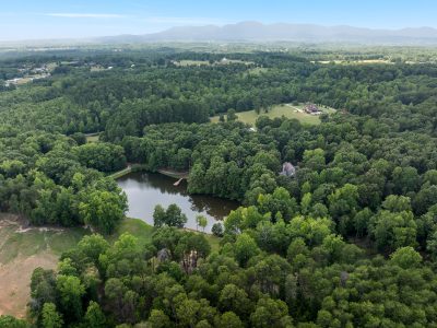Luxury acreage property with creek-fed pond and mature woods