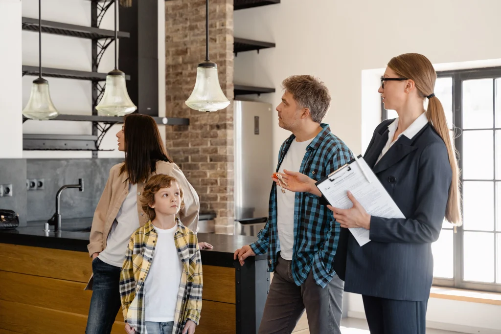 Real Estate Agent in a showing. Family with child there as well