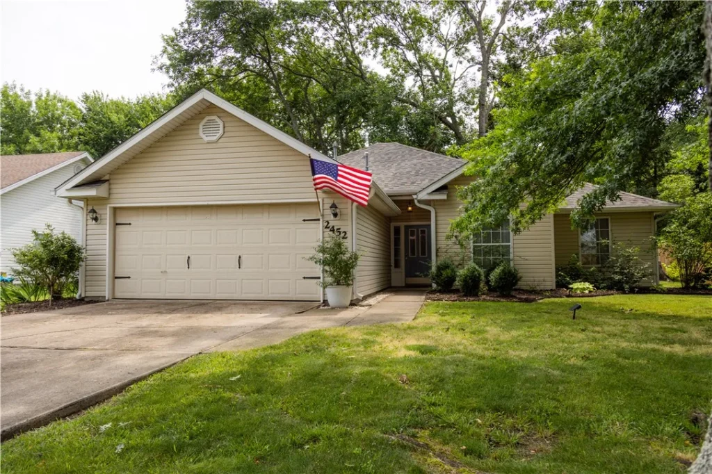 Street view of home for sale. American Flag waving out front