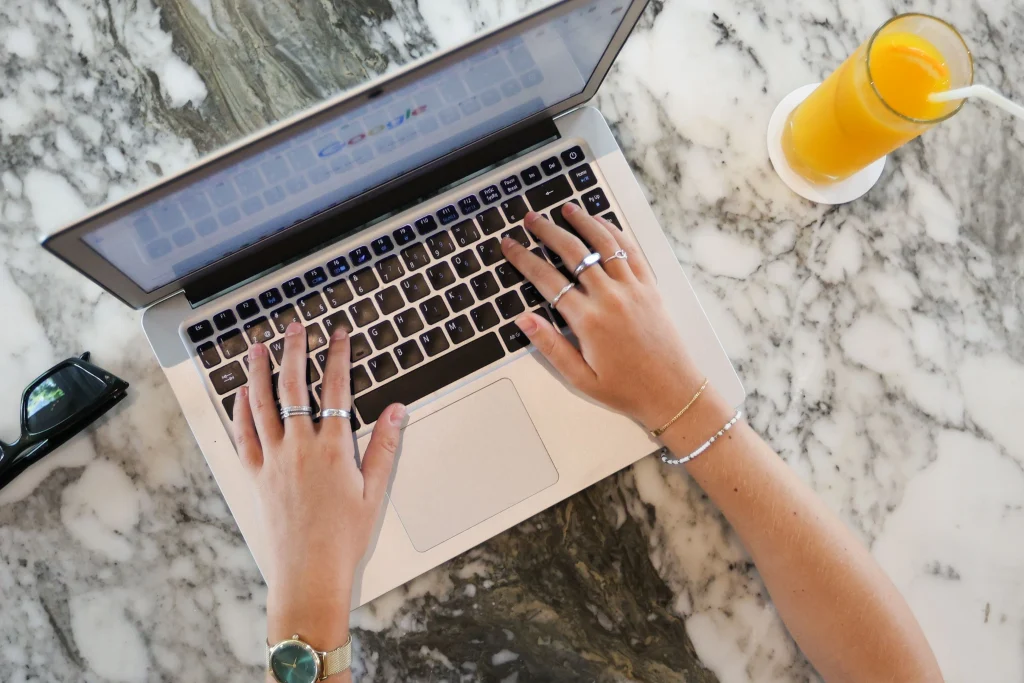 Top view of hands operating a computer.