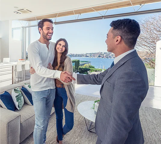 Real Estate Agent shaking hands with clients