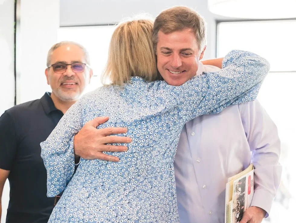 Real Estate Agent hugging client