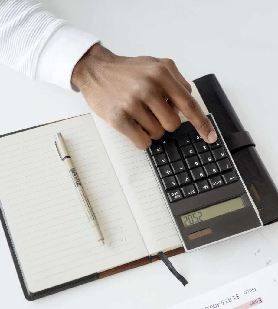 Hand punching in numbers on a calculator