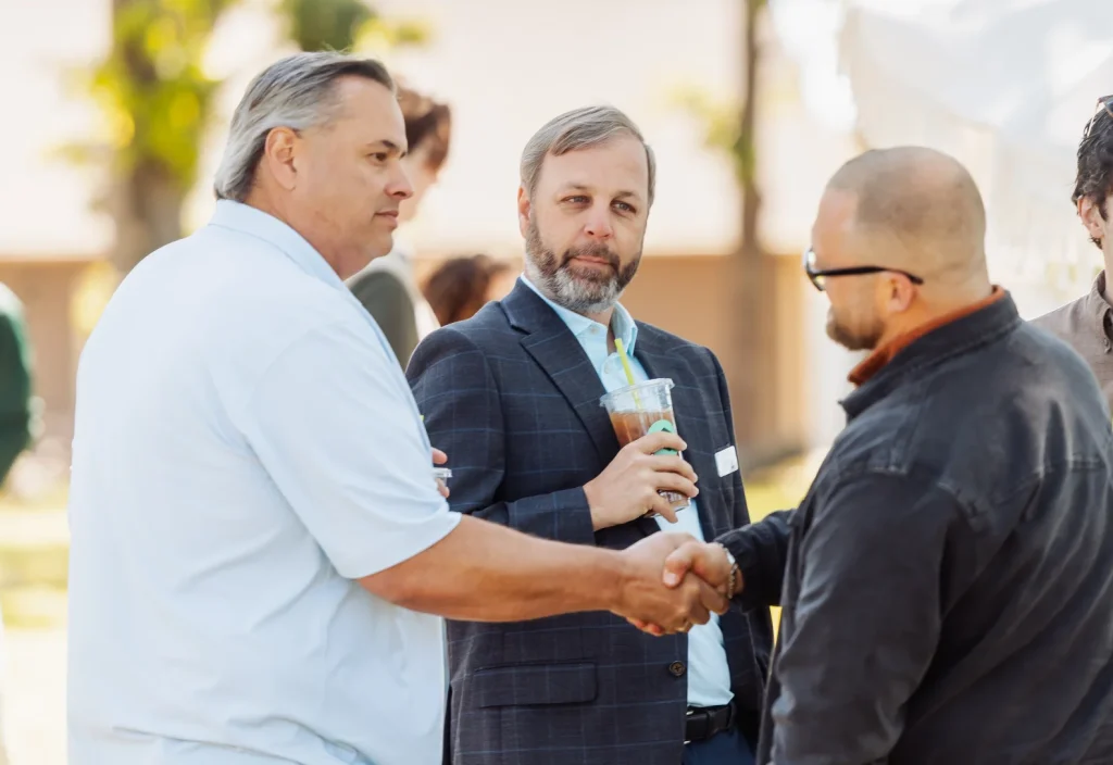 Real Estate Agents and Mortgage Lender meeting and shaking hands outside