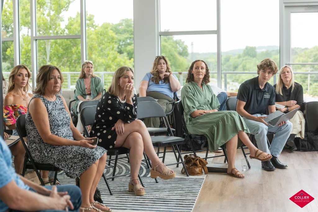 Group of people sitting listening to a presentation