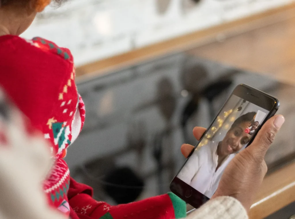 Real Estate Agent holding phone facetiming remote client